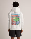 A man viewed from behind wearing a white hoodie with a large, colorful graphic print of a New York Giants football stadium on the back